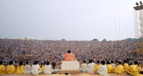 "The Woodstock Guru" Satchidananda Saraswati leads a prayer of peace and love to kick off the music festival.
