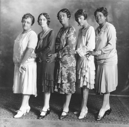 1920s black women wearing pretty floral dresses and strap heel shoes