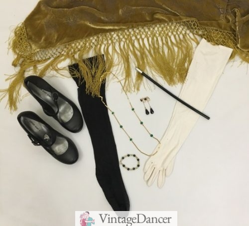1920s formal accessories: Mary Jane shoes, black stockings, gold fringe shawl, long white gloves, cigarette holder, drop earrings, gold and green bead necklace, green bead and pearl bracelet. More evening 20s ideas VintageDancer.com