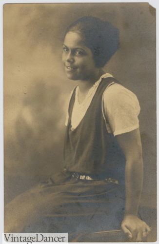 1920s black teenage girl in a jumper dress or pinafore dress over blouse