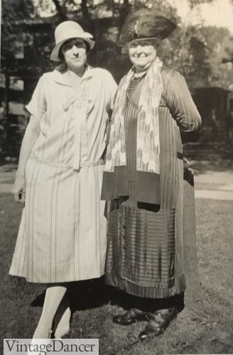 The daughter wears newer 1920s drop waist casual dress while the mother wears modest clothing of earlier times. 