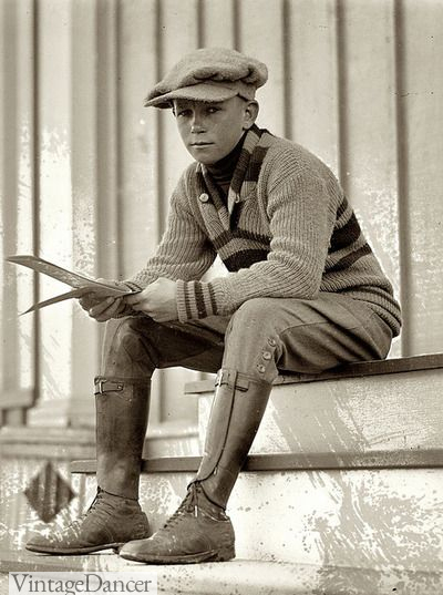 A young man dressed in breeches, puttees, shoes, sweater and newsboy cap. 