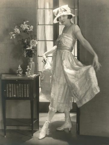 1921 Irene Castle, dancer, wears a light taffeta dress over a cream tulle and lace underskirts