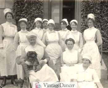 1921 West Suffolk, Britain. Wearing an older style of uniform with long full skirt and apron and high modest neckline
