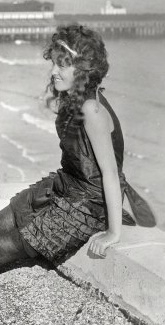 1922, a beach bather with long curly hair