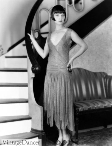 1925: Louise Brooks standing by the stairway.