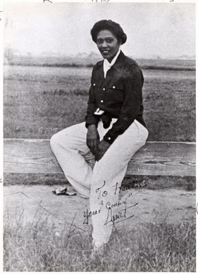 Janet Waterford Bragg, pilot, wears white wide leg pants with blouse and suede aviator style jacket. 1930s black women outfit. 1930s outfits at VintageDancer