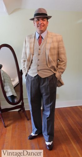 1940s men's fashion: sports coat over vest, wige leg trousers, wingtips and fedora hat
