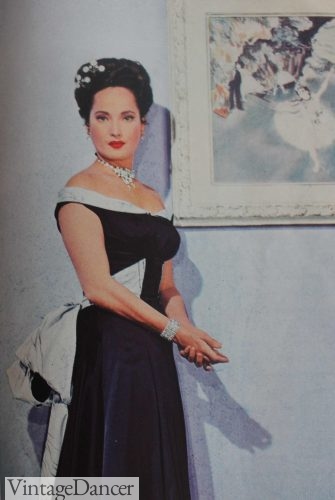 1946 black off the shoulder gown with white collar and bustle bow