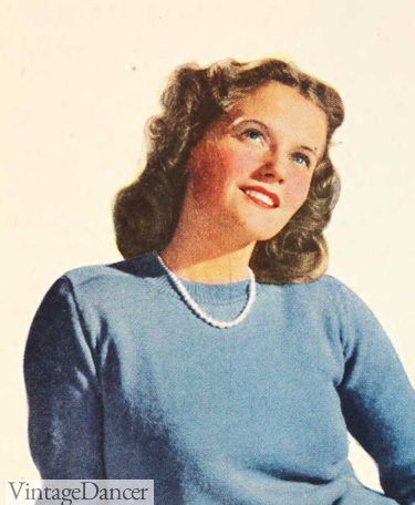 1946 teen wears a pearl necklace with her sweater