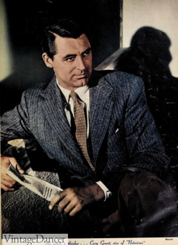 1948 Cary Grant wears a blue grey suit and brown tie 1940s actor photo in color