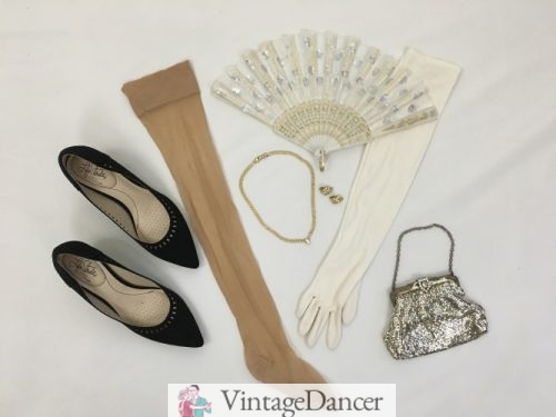1950s evening formal dress accessories: Kitten heels, nude stockings, gold necklace and earrings, white gloves, white, silver and gold lace fan and silver mesh clasp handbag. More ideas at VintageDancer