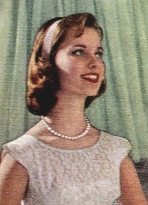 Teen wearing a headband and pearl necklace 1959