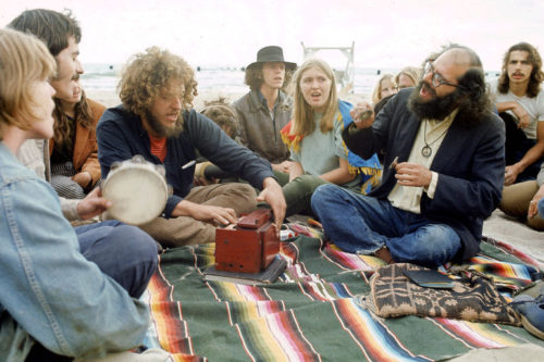60s mens hairstyles Allen Ginsberg singing to a group of hippies in 1968 at VintageDancer
