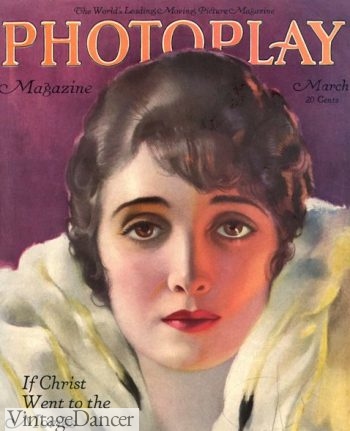 1920, notice her eye shadow matches her eyes and mascara in heavy on the top lashes