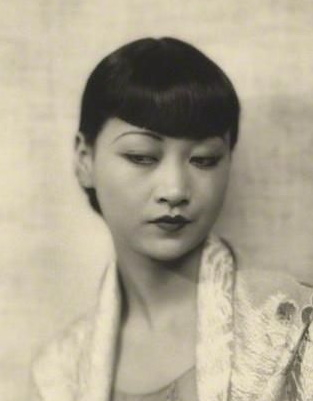 1920s Chinese hairstyles. Anna May Wong straight hair pulled back in a bun with bangs
