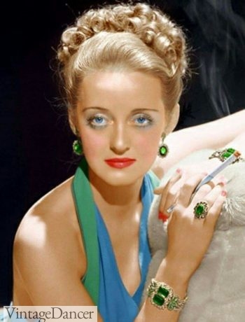 Full color jewelry was also common in evening wear in the late 1940s. Bette Davis. 