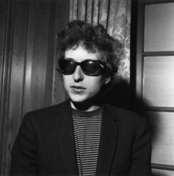 Bob Dylan, striped Breton shirt, skinny sport coat, and dark sunglasses.