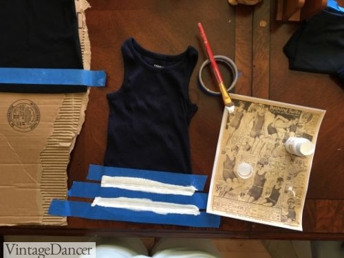 DIY 1920s swimsuit-Painting stripes on a ribbed tank top using masking tape to make even lines.