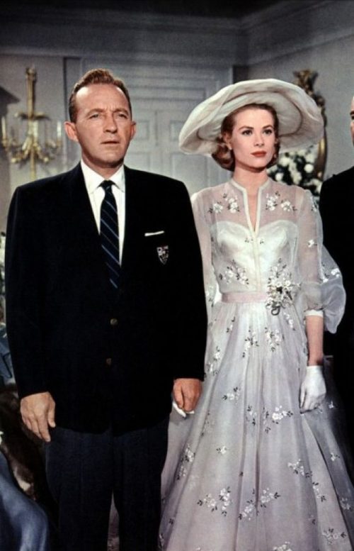 1956, High Society, wedding with groom, Bing Crosby, wearing a dark blue suit coat, grey trousers, and striped necktie.