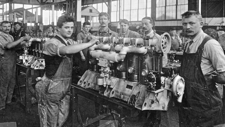 Edwardian early 1900 mens work clothes: Factory workers at Hall Scott Engines wearing overalls white or blue shirt and tie.