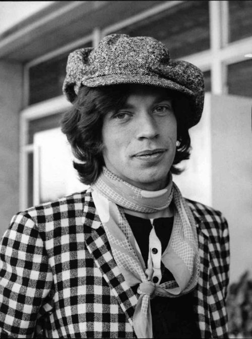 Mick Jagger wears a newsboy style cap