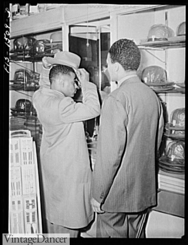 1942 Mr. Claude Walker trying on a new hat in the Henry C. Taylor Store (he is wearing a zoot suit)