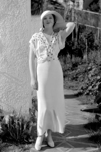 Myrna Loy wearing a polka dot scarf in 1933.