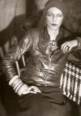 Nancy Cunard, 1928, wearing bangles with her leather jacket