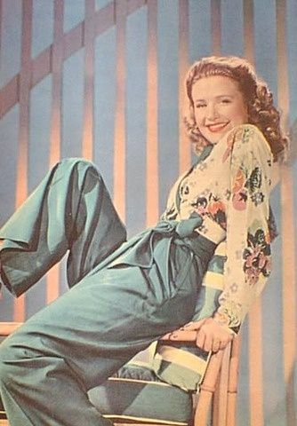 Priscilla Lane wearing her pants with a floral printed blouse