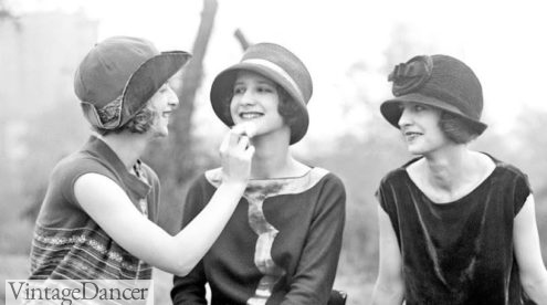 The Duncan Sisters touching up with face powder 1920s makeup application