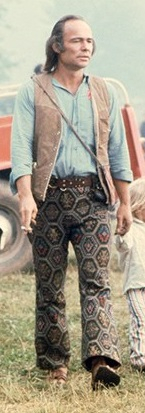 Woodstock man wearing tile print trousers and vest