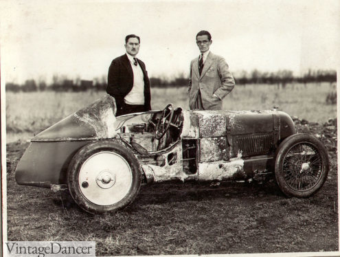 George Eyston Daytona Bonneville Land Speed Record Breaker, upper class man in finery with fire damaged 1930s race car - at VintageDancer.com