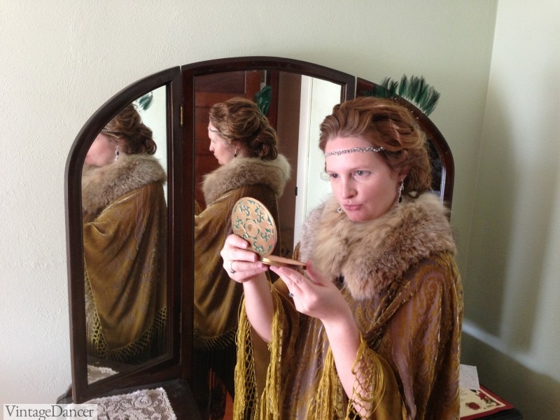 Checking makeup in my 1920s style fringe shawl and fur collar