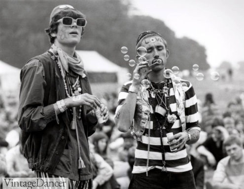 1960s hippie clothes - two eccentrically dressed hippie men blowing bubbles in during the 1967 Summer of love at VintageDancer
